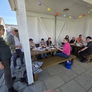 Fröhliche Runde beim Grillieren in einem Unterstand